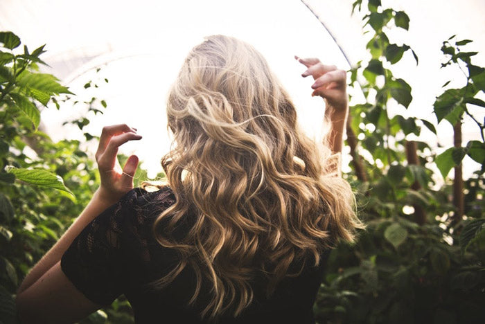 blond woman walking through nature