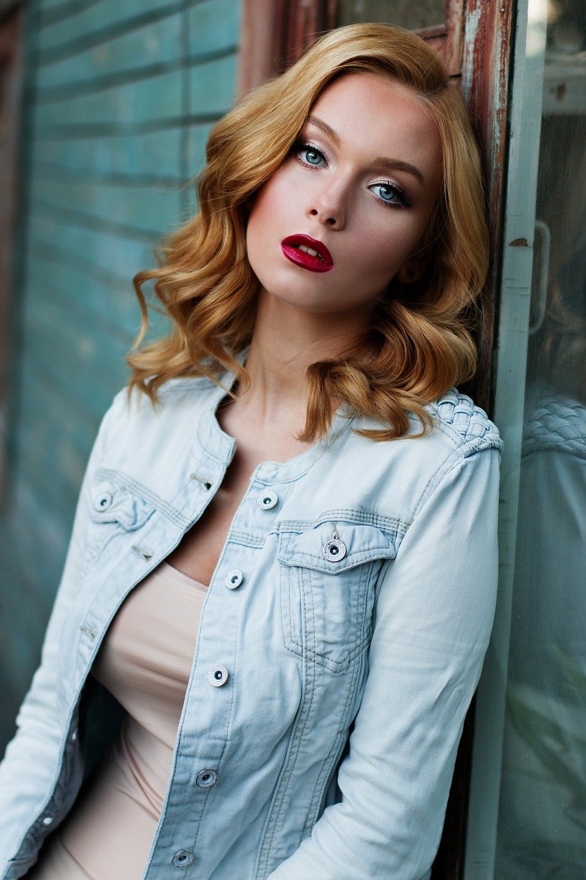 a woman with red hair styled in elegant loose waves