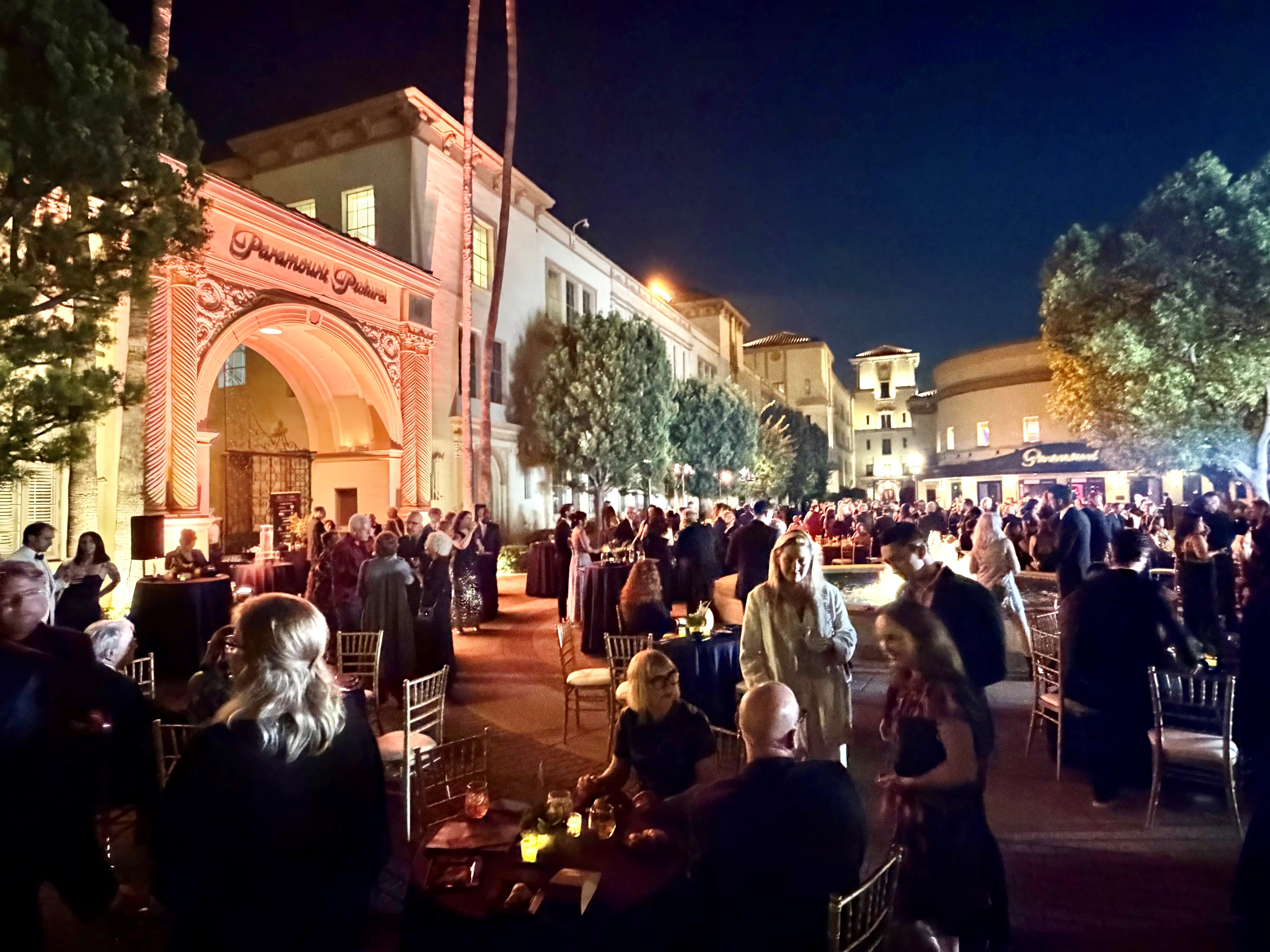 Image of Property Masters Guild members attending 2026 MacGuffin Awards dining after the ceremony on the plaza outside the Paramount Theatre at Paramount Pictures.