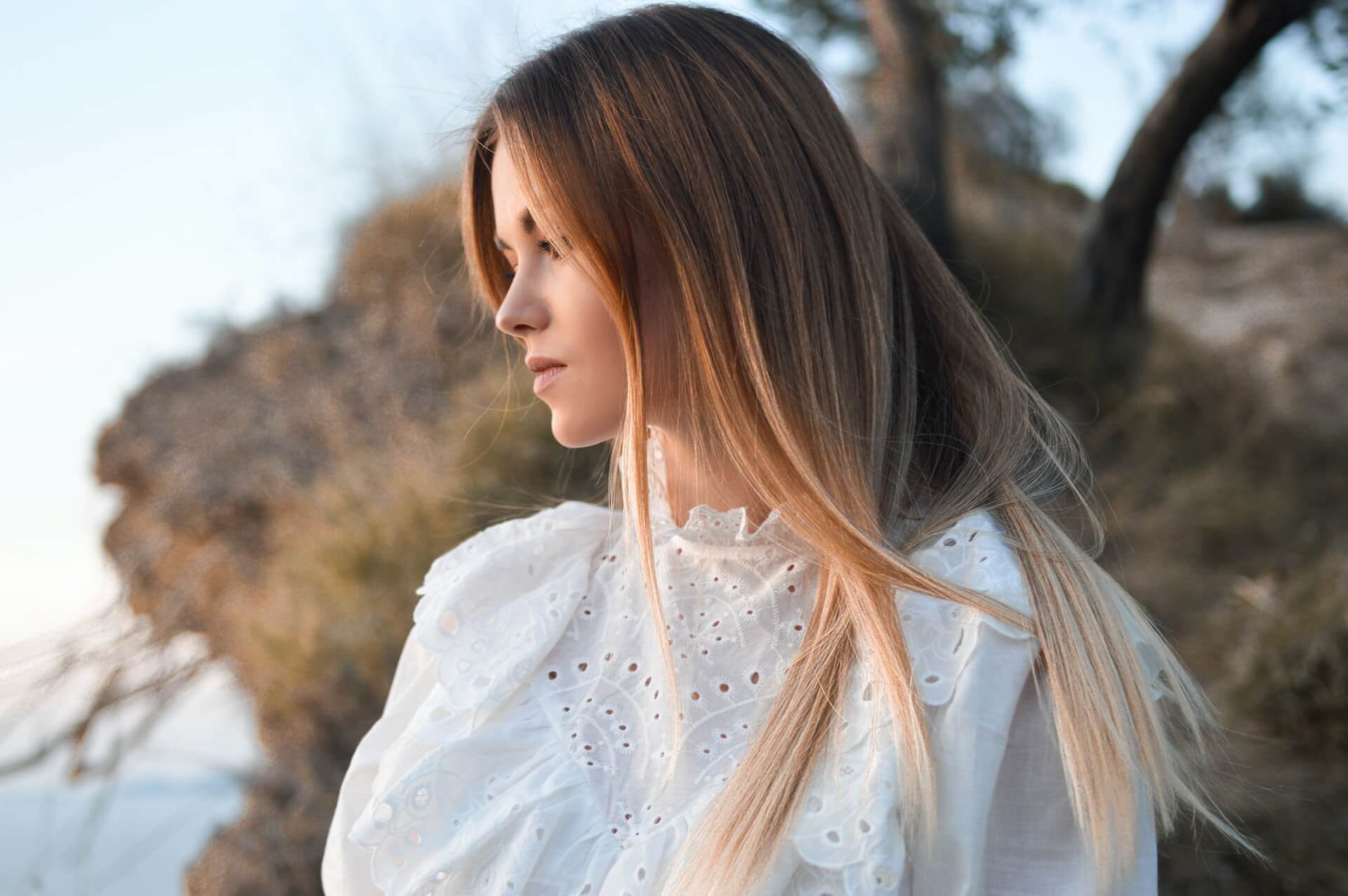 woman with luscious locks in a white shirt