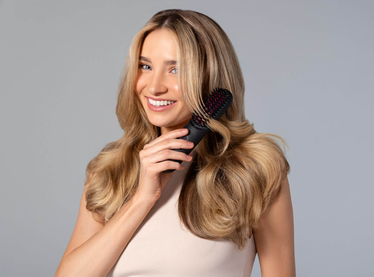 Woman brushing her styled hair
