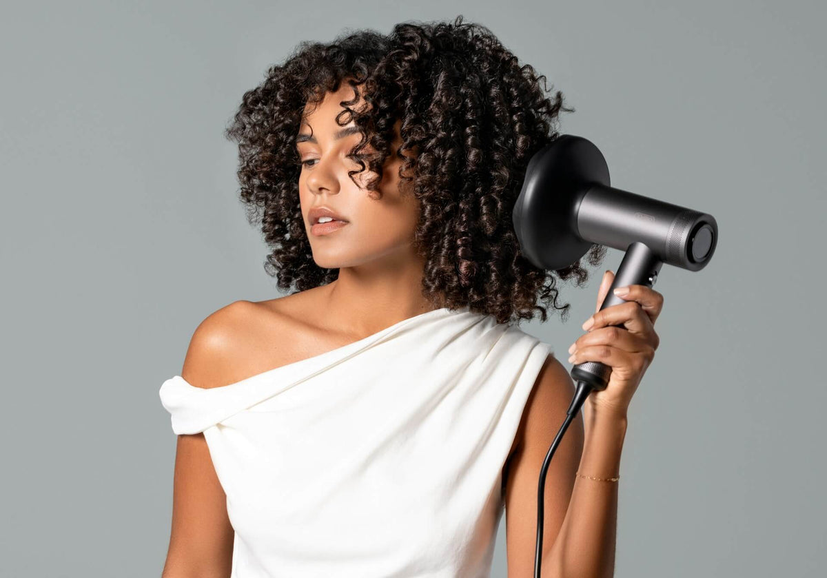 Woman holding a blow-dryer
