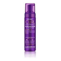 A purple bottle of Giovanni Cosmetics CURL HABIT™ CURL DEFINING HAIR MOUSSE with a pump dispenser, made for all curl types and flexible hold. This alcohol-free, silicone-free formula with shea butter delivers salon-quality results.