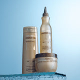 Bottles of Smoothing Castor Oil Conditioner, Hair Mask and 100 percent Castor Oil sitting on glass shelf. 