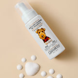 Giovanni Cosmetics PROFESSIONAL WATERLESS FOAMING PET SHAMPOO - OATMEAL & COCONUT features an illustrated dog on the label, surrounded by foam bubbles on a beige background—ideal for pets needing gentle, sensitive skin care.