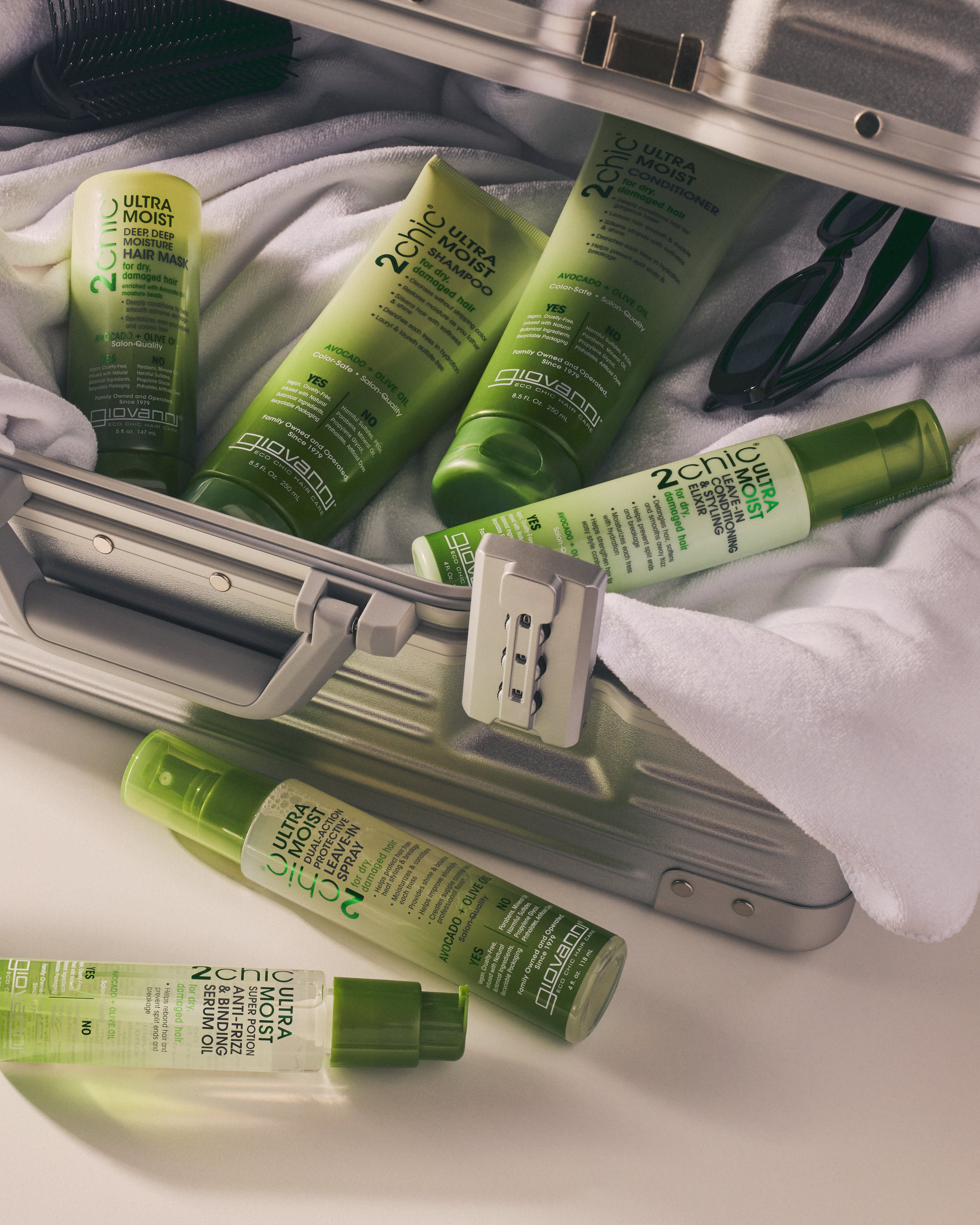 Image of complete 2chic Ultra Moist hair care collection in hard-sided travel bag.