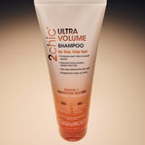 Image of 2chic Ultra Volume Shampoo from above with ombre background.