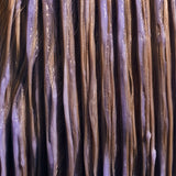 Image of Purple Conditioner combed through blonde hair