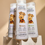 Three white bottles of Giovanni 2-in-1 Pet Shampoo & Conditioner arranged on a pedestal with gel, shown against a warm beige background.