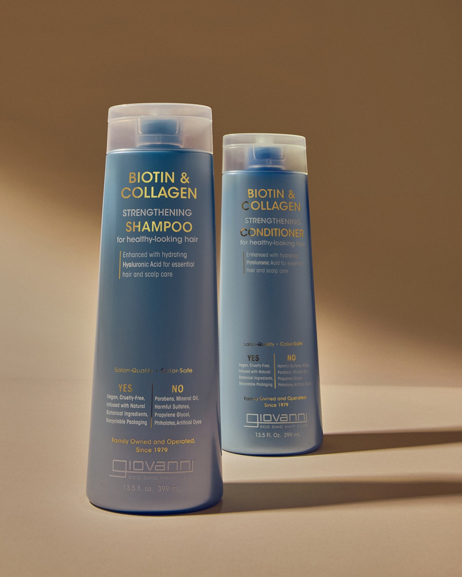 Two bottles of Giovanni Biotin & Collagen hair care products, including Strengthening Shampoo and Strengthening Conditioner, standing against a matching beige background.