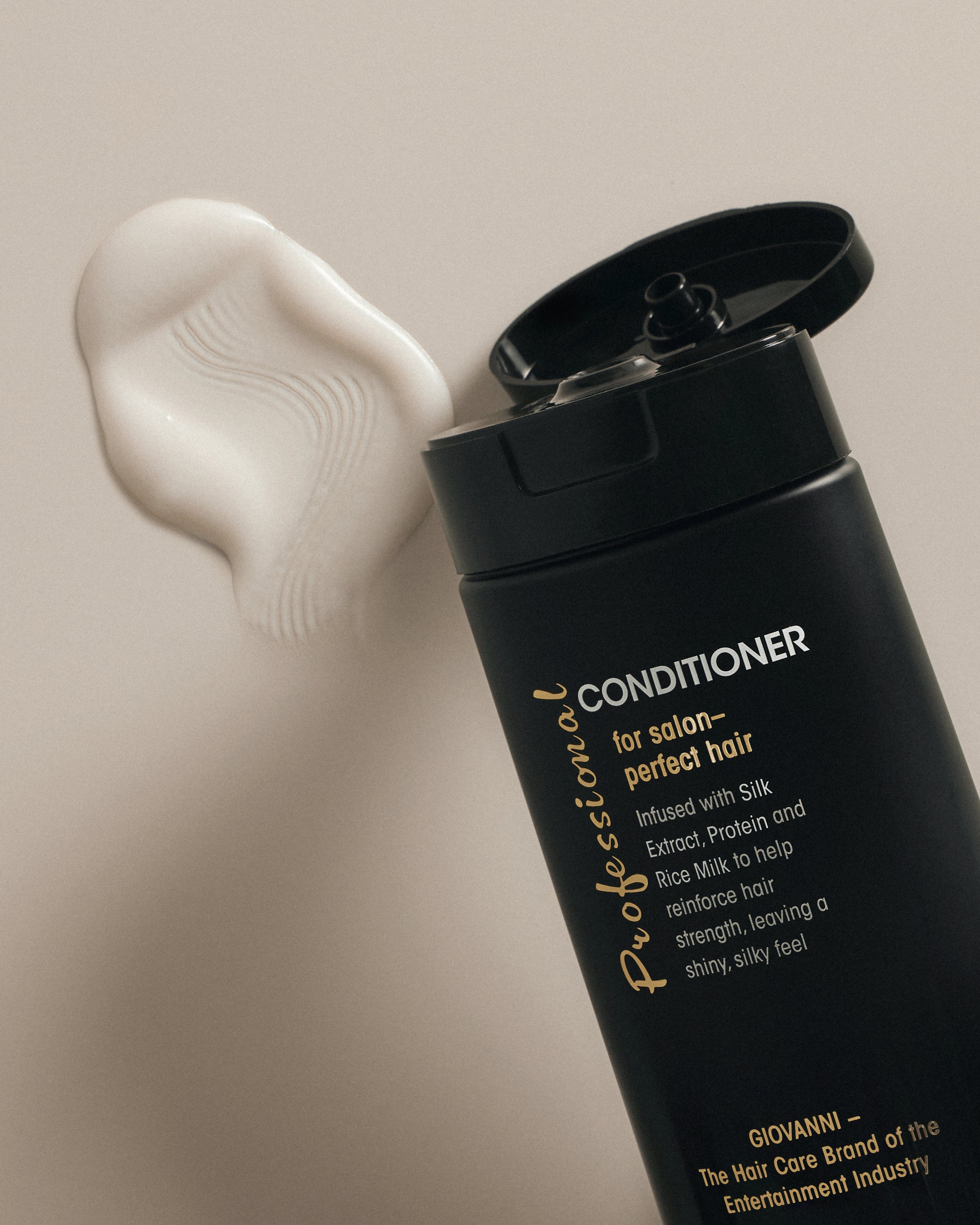 Image of Giovanni Professional Conditioner open with conditioner on surface