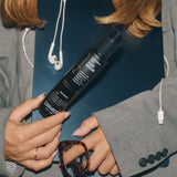 Image of woman holding bottle of Giovanni Professional Hair Serum