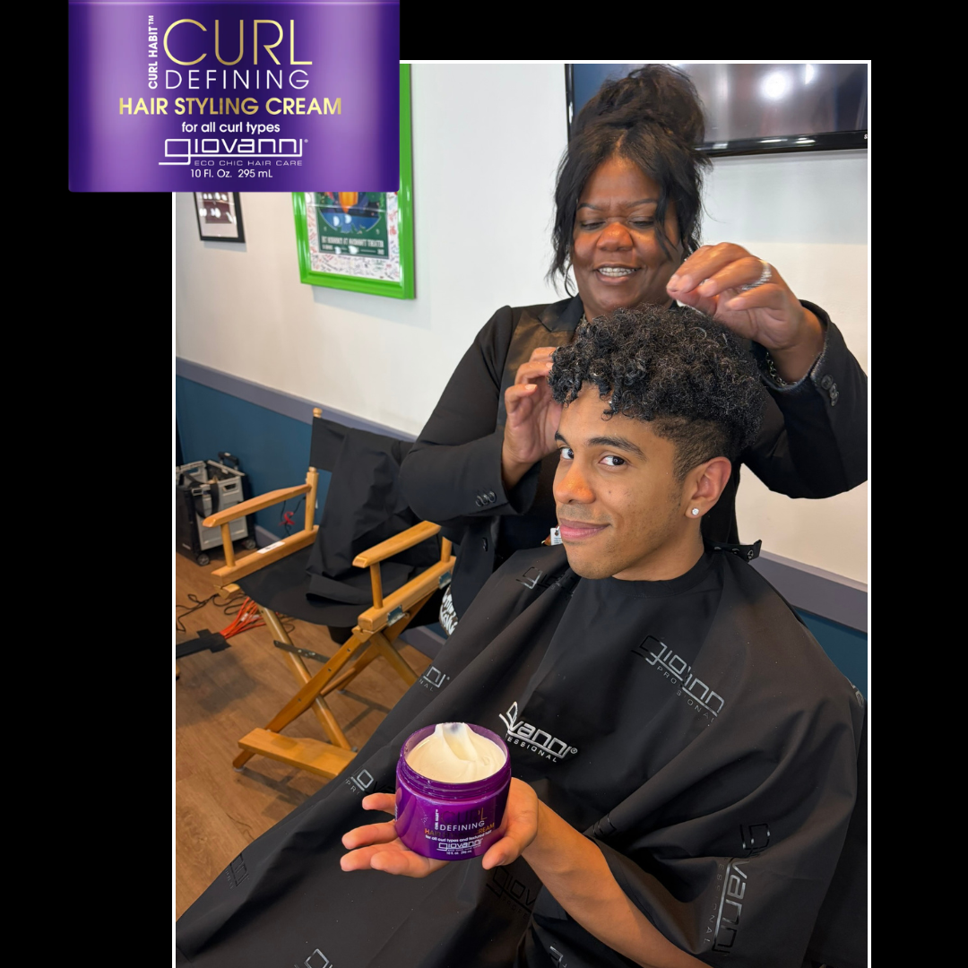 A lifestyle scene showing a hairstylist styling a client's curly hair, with a purple Giovanni curl defining hair styling cream jar featured in the top-left corner and held by the client.