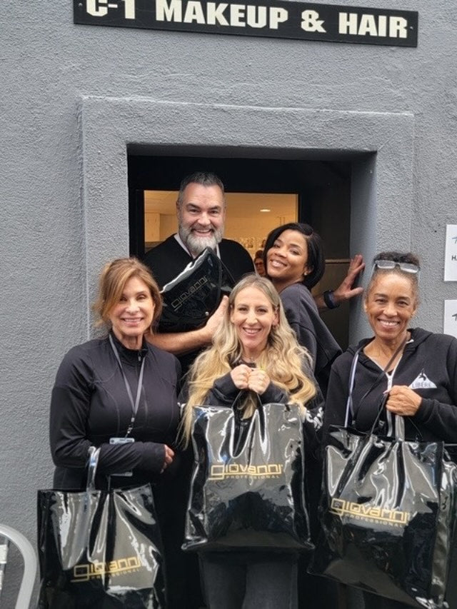 Group of people standing in front of a business entrance with 'C-T Makeup & Hair' sign.