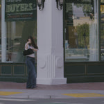 Video showing woman on busy sidewalk reaching for Giovanni's Ultra Moist Super Potion Serum for a quick hair fix. 