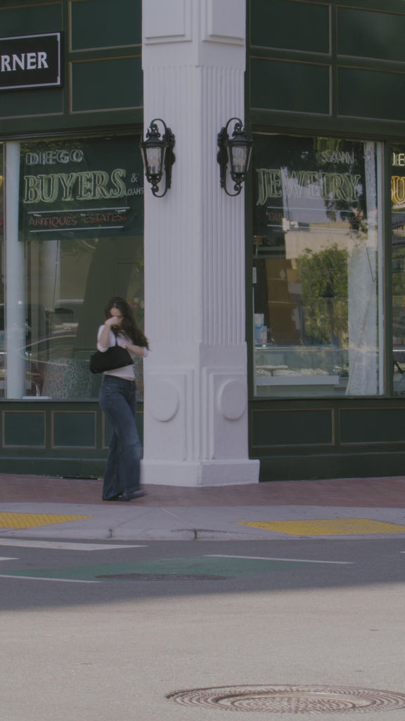 Video showing woman on busy sidewalk reaching for Giovanni's Ultra Moist Super Potion Serum for a quick hair fix. 